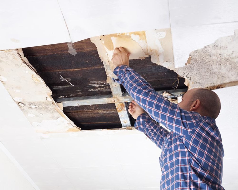 homeguide-contractor-fixing-drywall-ceiling-hole-and-collapsed-panel